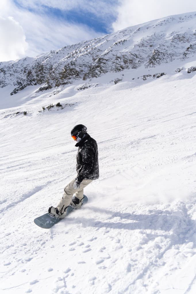 Snowboarder carving down a mountain slope